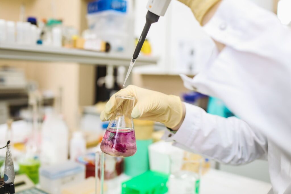 Scientist using a pipette for chemical analysis in a laboratory