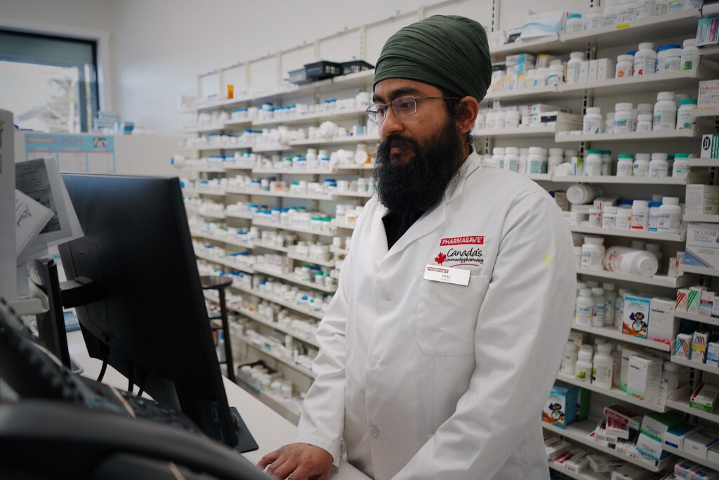 Pharmacist using a computer in a licensed pharmacy