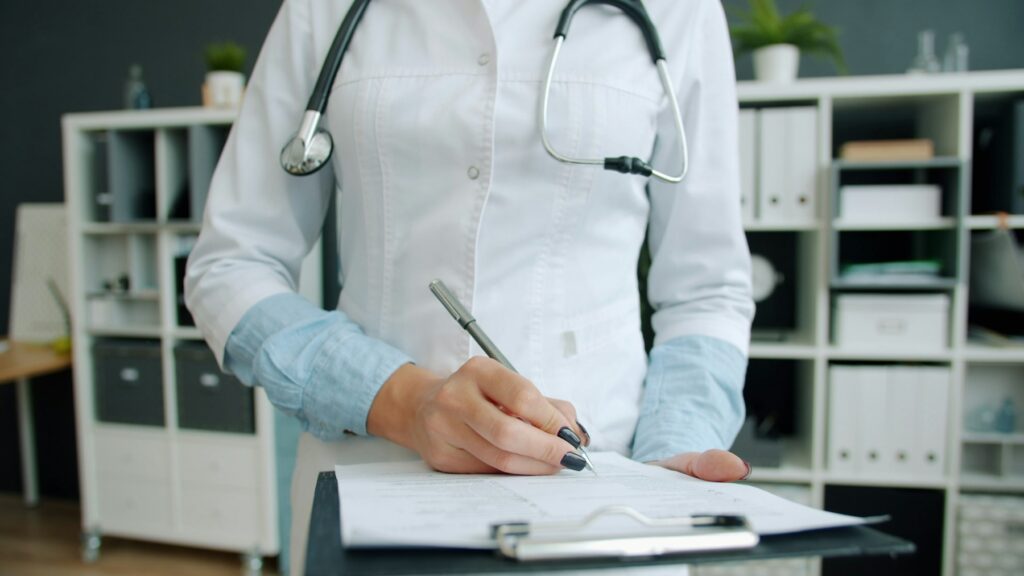 Doctor reviewing medical records on a clipboard