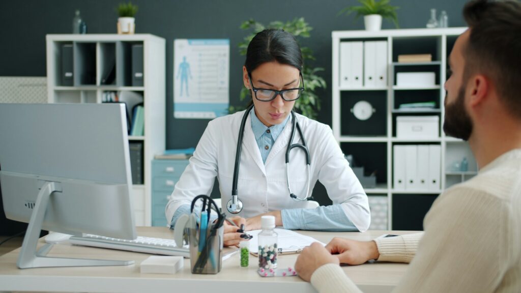 Doctor consulting with a patient at a desk