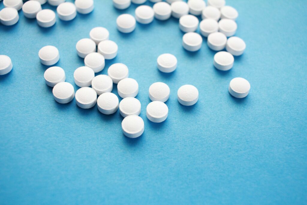 Medication pills on a blue surface