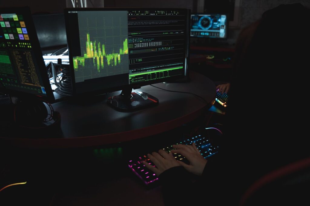 Computer monitors displaying data and cybersecurity information