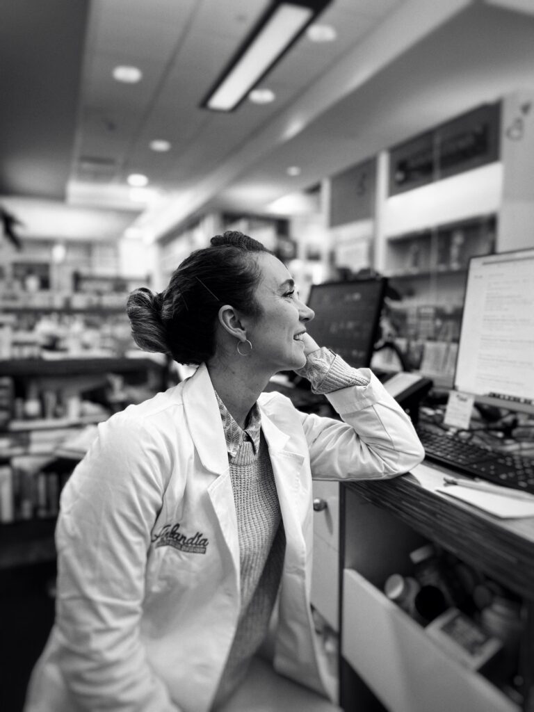 Pharmacist using a computer in a pharmacy